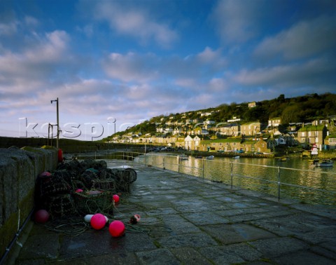 Early morning sun illuminates this picturesque Cornish fishing village on a bright Autumn morning Th