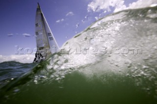 Above and below the water surface as a yacht rounds the windward mark on Day 5 of the Rolex Commodores Cup 2008 in the Solent, UK.