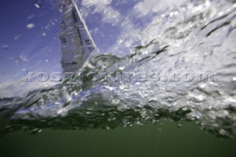 Above and below the water surface as a yacht rounds the windward mark on Day 5 of the Rolex Commodor