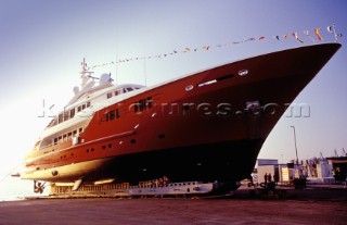 Lanscape of the build and launch party ceremony from a slipway of the red superyacht Elix
