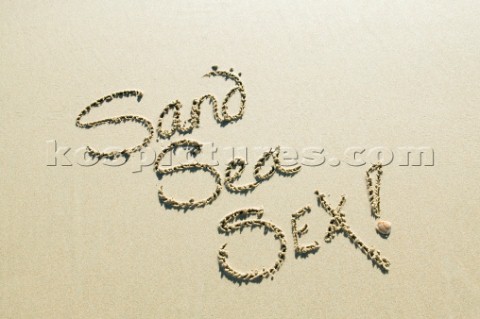 Sand Sea Sex sign writing message on a sandy beach in Tarifa Spain near Gibraltar