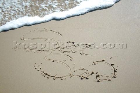 Sea Sand sign writing message on a sandy beach in Tarifa Spain near Gibraltar