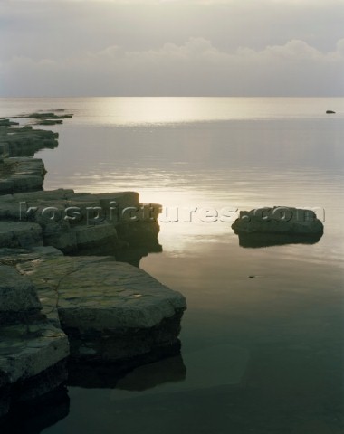 Soft golden light on a very calm sea along teh Dorset Coast  Limited Edition prints available
