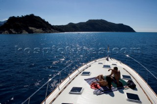 A romantic couple relaxing onboard a Vicel 72 classic motor yacht.  Model Released.
