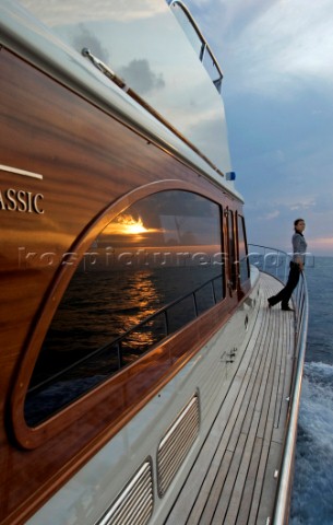 A romantic couple relaxing onboard a Vicel 72 classic motor yacht  Model Released