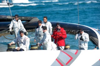 FEBRUARY 12TH 2010, VALENCIA, SPAIN: Ernesto Bertarelli (in red) on Alinghi 5 catamaran during the 1st match of the 33rd Americas Cup in Valencia, Spain.