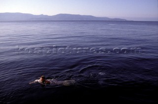Man swimming in the deep water off the coast of the British Virgin Islands