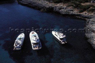 Fairline Squadron 52, Phantom 42 and Targa 43 at a secluded anchorage in clear shallow water
