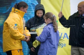 SOUTHAMPTON, UK. MAY 21: Solo round the world yachtswoman Dee Caffari (33)revieving the Trophy from Princess Ann in torrensial rain at Ocean Village Southampton. She is the first woman to sail solo around the world against the wind and tide.