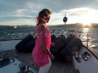Lady guest in evening wear onboard superyacht in the Mediterranean