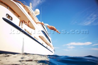 Man diving into the mediterranean sea from a superyacht