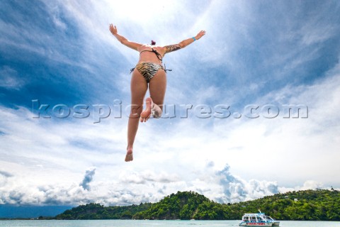A girl jumps from the roof of a boat into the ocean off the coast of Costa Rica