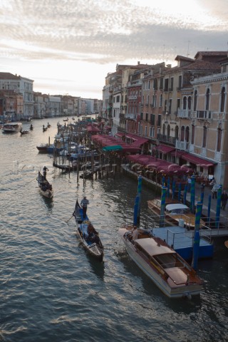 Two gondolas with tourist sails along the great canal viewed from Rialto bridge in Venice Italy