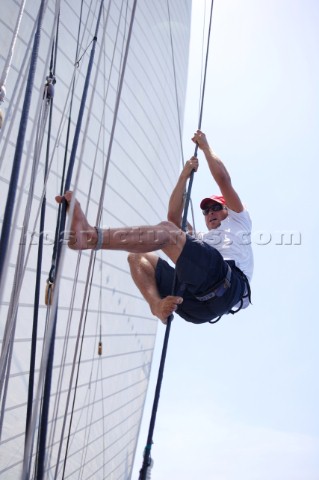 Crewman climbing aloft on board sailing yacht Altair during the Antigua Classic Regatta Antigua Brit