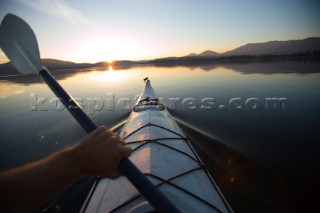 Woods Wheatcroft paddles out on Lake Pend Oreille in Sandpoint Idaho.  Photographing the fall colors in North Idaho.