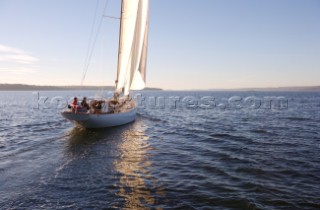 View of the yacht Anna, a 56 foot Spirit of Tradition class sloop, designed by Sparkman & Stephens being taken out for a sunset sail off the coast of Maine.  (release code: RP08004, RM08003, RM08004)