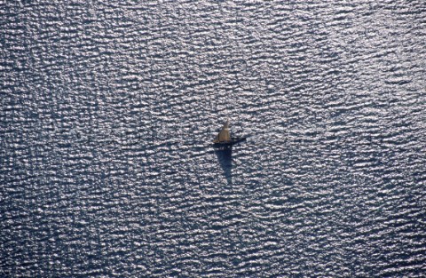 Aerial view of a fishing dhow sailing in shallow water near Kiwayu island off the northern coast of 