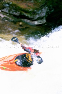 Kayaker Lane Jacobs takes a drop over a small waterfall on Cow Creek, northern Idaho. Every spring small creeks in northern Idaho near the Canadian border become runable. Kayakers from throughout the West make the trip to go. Woods Wheatcroft/Aurora Photos