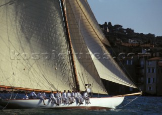 Crew on the windward rail of classic sloop during racing in Saint Tropez