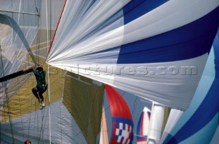 Bowman at the end of a spinnaker pole preparing to blow the sail