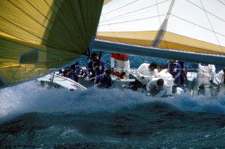 Crew racing on maxi yacht in rough conditions
