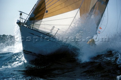 Bow of a Swan yacht bursting through a wave