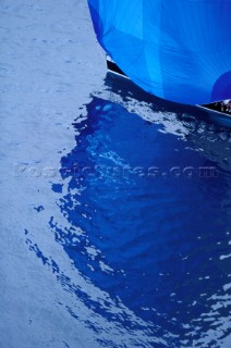 Reflection of blue spinnaker in rippled water