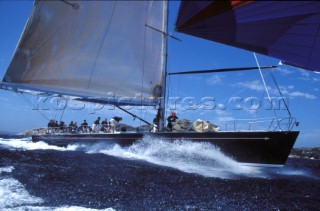 Maxi yacht sailing downwind under spinnaker