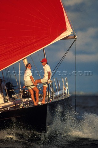 Two people on the bow of a yacht 