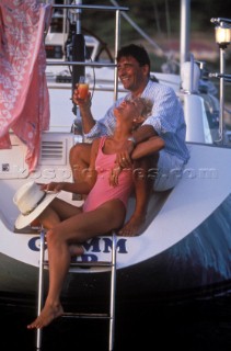 Romantic couple of the back of a Swan 55 cruising yacht