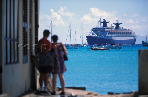 Cruise Liners Philipsburg St Maarten 1999 A couple stand on a dock looking at a cruise ship in the h