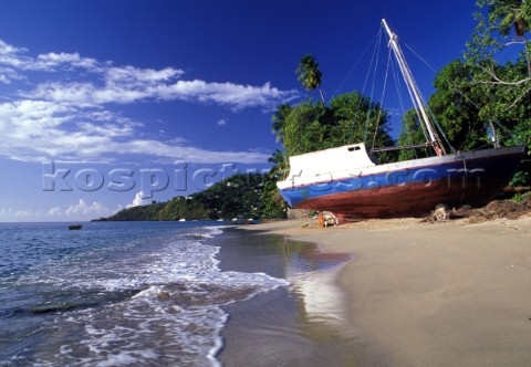 Old wooden fishing boat on sandy beach Grenada Caribbean