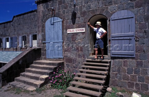 Man standing in doorway of Poice station Nevis Caribbean