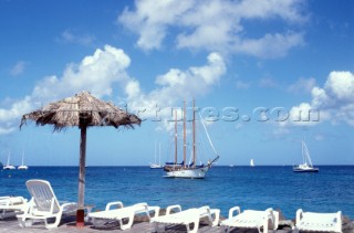 Classic schooner anchored off beach resort in Martinique, Caribbean