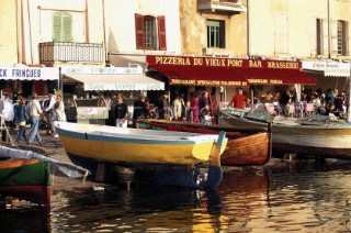 Wooden fishing boats pulled out of water in the port of St Tropez, France