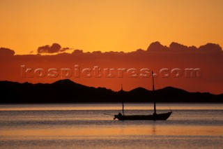 Anchored yacht at sunrise on still water Baja, California