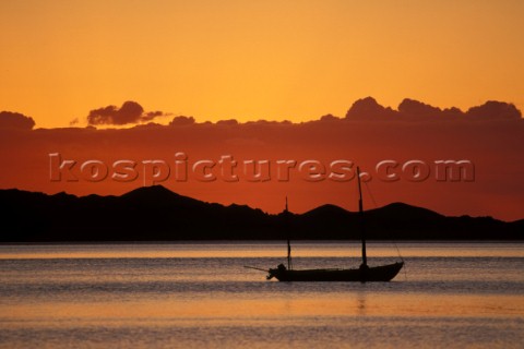 Anchored yacht at sunrise on still water Baja California