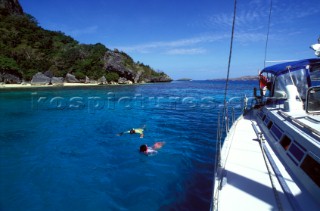 Swimming and snorkling off a cruising yacht on the coast of Fiji