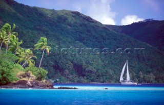 Cruising yacht sailing into anchorage - Tahiti