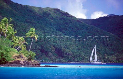 Cruising yacht sailing into anchorage  Tahiti