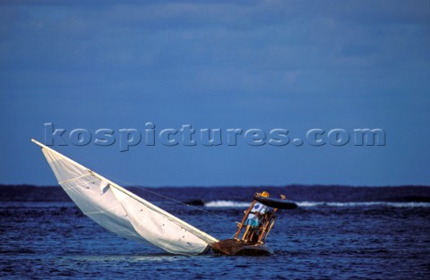 Man capsizing tradition polynesian sailing boat