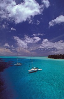 Two yachts at anchor in shallow water - Tahiti, French Polynesia