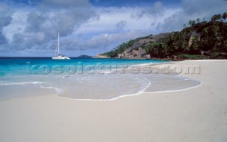 Yacht anchored off idyllic sandy beach - Seychelles