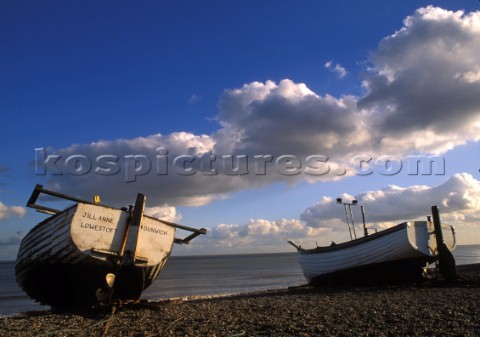 Two fishing boats on the shingle at Dunwich Beach Suffolk UK