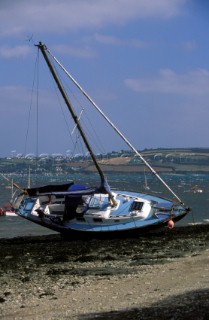 Westerly cruising yacht washed ashore following a storm which broke its anchor chain, Mylor, Cornwall