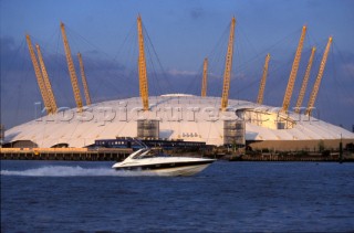 A Sunseeker powerboat in front of The Millenium Dome on the River Thames in London, UK