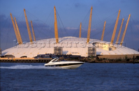 A Sunseeker powerboat in front of The Millenium Dome on the River Thames in London UK