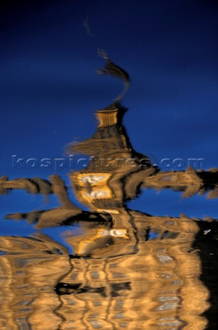 Artistic water reflection of Big Ben by the River Thames in London UK