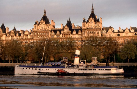 Grand architecture and the paddle steamer Tattershall Castle on the banks of the river Thames London
