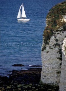 Cruising UK - yacht sails past Old Harry Rocks Poole Harbour